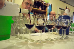Owner Joal Wolf, pours wine into glasses for taste testing.